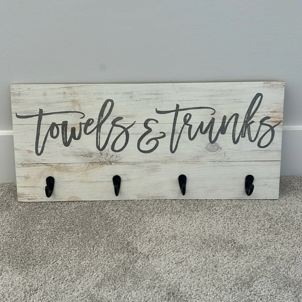 Wooden towels and trunks sign